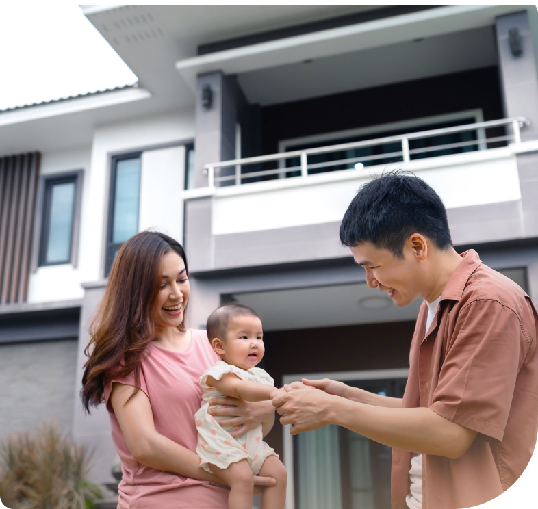 Father mother and their child look like a happy family in front of their home.